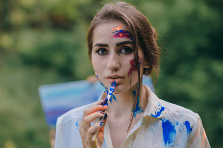 woman-painting-blue-lip-with-paintbrush_1157-2298