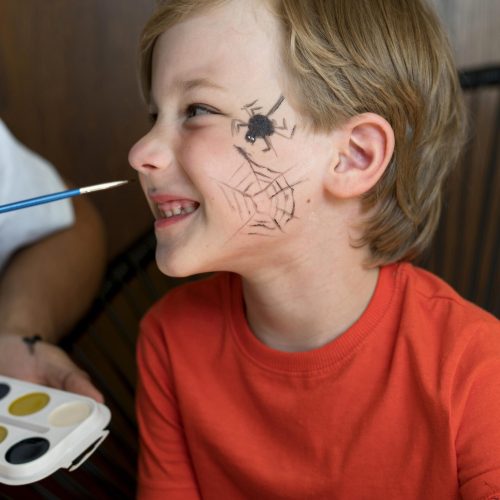 close-up-smiley-kid-with-face-painted-halloween