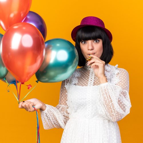 impressed-young-party-girl-wearing-party-hat-holding-balloons-holding-party-horn-mouth-isolated-orange-wall_141793-114626 (1)