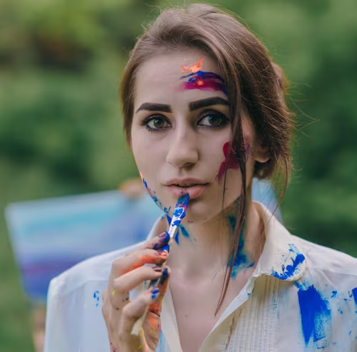 woman-painting-blue-lip-with-paintbrush_1157-2298
