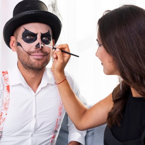 woman-painting-her-man-halloween_23-2148285536